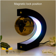 Load image into Gallery viewer, C shaped Floating levitation anti gravity black and gold globe desk lamp featuring two matching gold bees.
