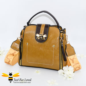 Flap over bumblebee two-toned vegan friendly leather handbag in mustard yellow colour.