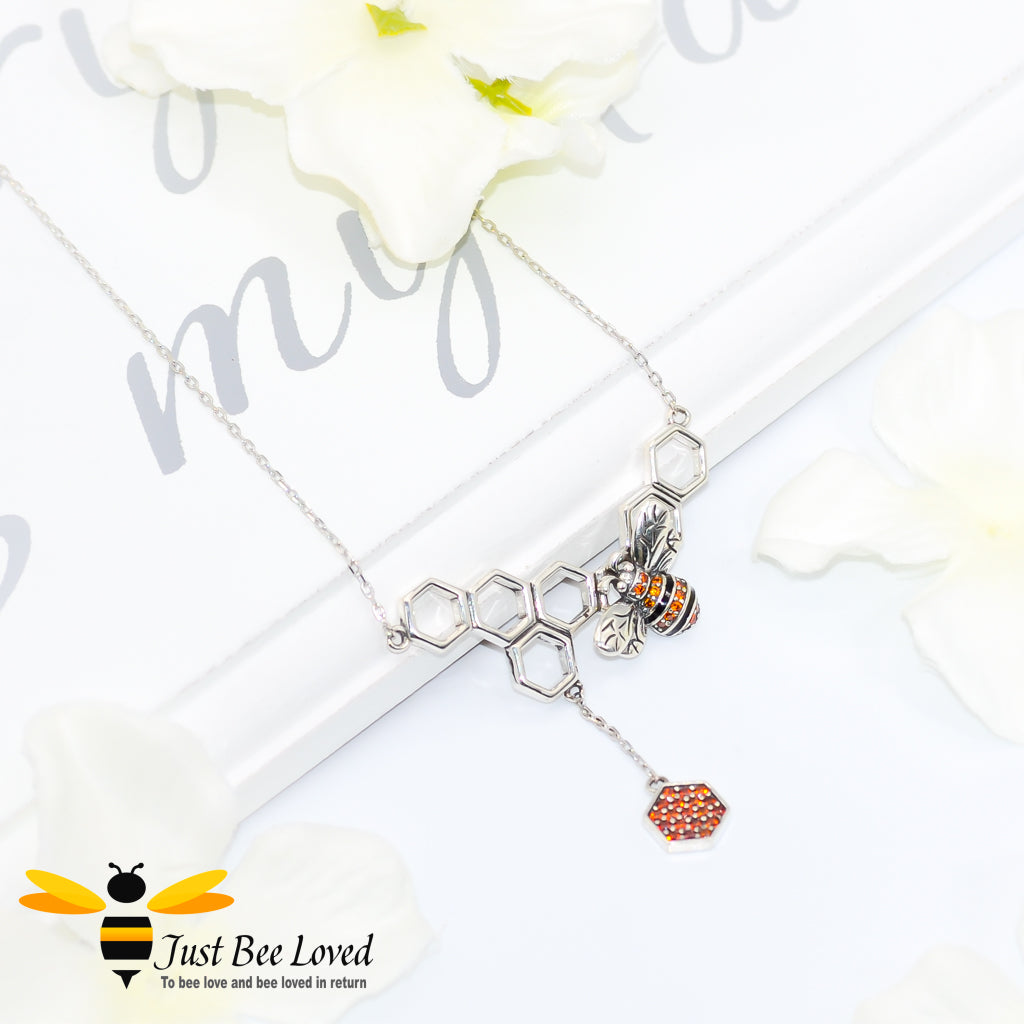 Sterling Silver 925 Necklace with sterling silver bee pendant encrusted with black and orange cubic zirconia on a honeycomb with honeycomb dangle