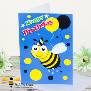 Just Bee Loved Little Bee Happy Birthday Greeting card for boy featuring bumble bee with a party hat and balloons design by Artist Yasmin Flemming