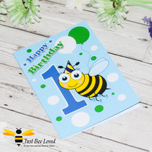 Load image into Gallery viewer, Just Bee Loved Little Bee Happy 1st Birthday for boy greeting card featuring a cute bumble bee with a party hat with the number 1 and balloons design by Artist Yasmin Flemming