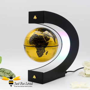 C shaped Floating levitation anti gravity black and gold globe desk lamp featuring two matching gold bees.