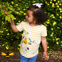 Load image into Gallery viewer, Little girl wearing a summer yellow striped T-shirt embroidered with honey bees, beehive and flowers.