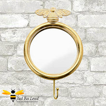 Load image into Gallery viewer, Gilded gold round mirror with hanging wall hook and brass bee feature