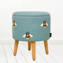 Load image into Gallery viewer, Meg Hawkins bumblebee illustration round storage footstool in teal blue colour with wooden legs
