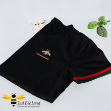 Load image into Gallery viewer, 2-piece black t-shirt and shorts embroidered with a gold bee and colour coordinating red & green stripes.