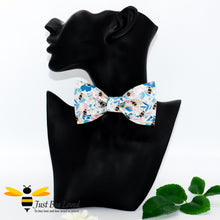 Load image into Gallery viewer, pre-tied white bow tie featuring an all over colourful print of bumblebees amongst a floral splash background