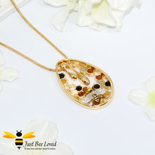 Load image into Gallery viewer, gold plated pendant necklaces each featuring golden honey drips, enamelled filled honeycomb to look like pollen with a honeybee.  