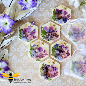 display of scented botanical vegan wax tablets decorated with purple natural flowers, gold bee, fragrance amber & spiced plum