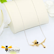 Load image into Gallery viewer, handcrafted sterling silver necklace featuring a design of an 18kt gold plated and black 3D honey bee resting upon golden dripping honey. 