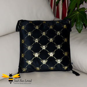 Black velvet scatter cushion with all over gold bumblebees