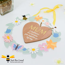 Load image into Gallery viewer, A wooden hanging plaque with a heart-shaped cut-out in the center, surrounded by colourful artificial flowers, bee motifs and the word 'MUM' inscribed on the heart.