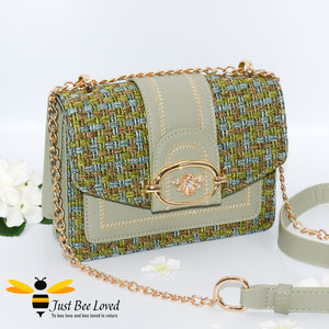 Woven faux leather handbag with gold bee decoration in green colour