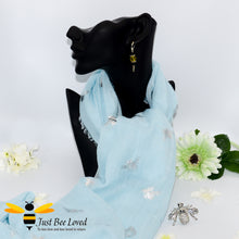 Load image into Gallery viewer, Women's light blue  lightweight scarf with silver bees print, and crystal silver bee brooch.