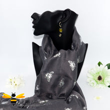 Load image into Gallery viewer, ladies scarf featuring metallic silver bumblebee print in dark grey, gift boxed with crystal bee brooch.