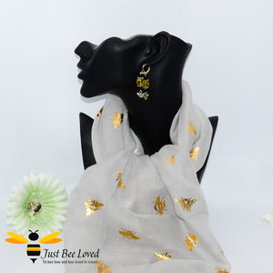 ladies scarf featuring metallic gold bumble bee print in beige colour, gift boxed with crystal gold bee brooch.