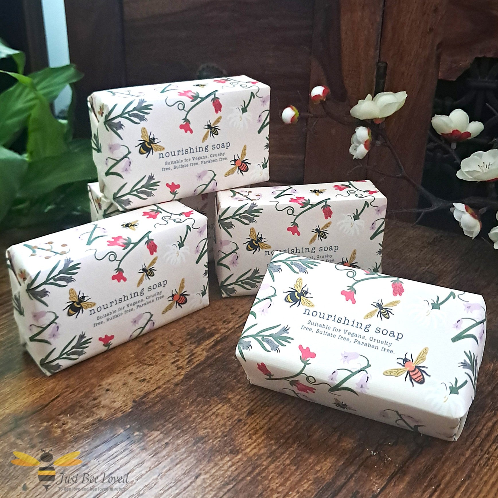 Bars of vegan hand soap with floral and bee themed design packaging.