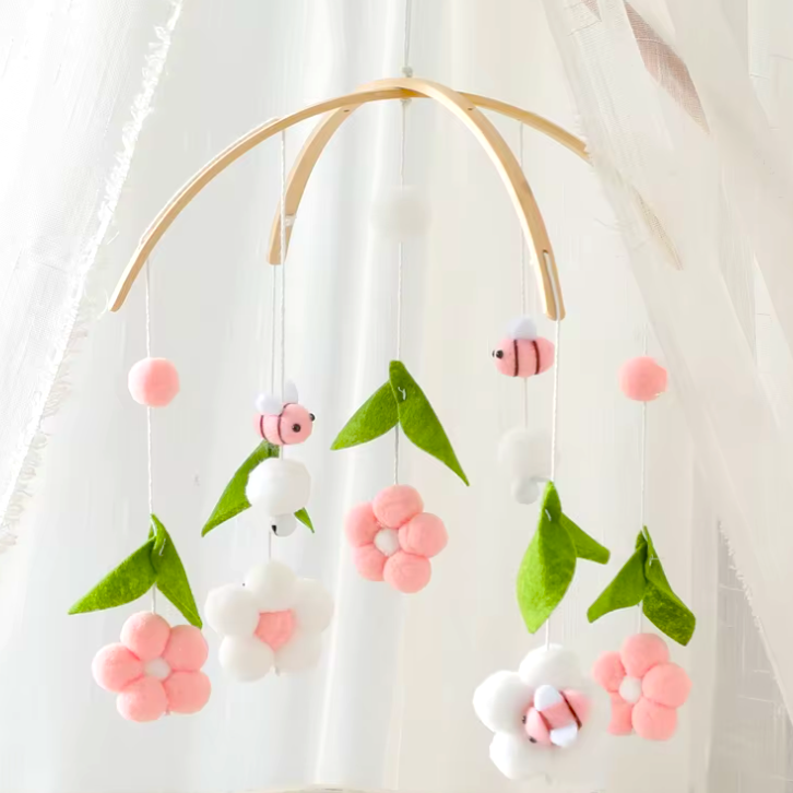 Honey bees and flowers fabric cot crib mobile in pink and white colours with wooden mount stand.