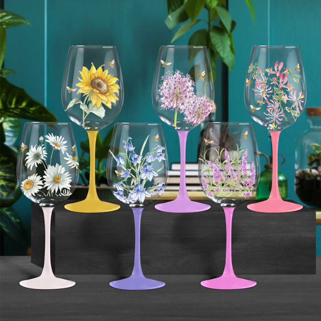 Tall coloured stemmed wine glasses with florals and bumble bees decoration