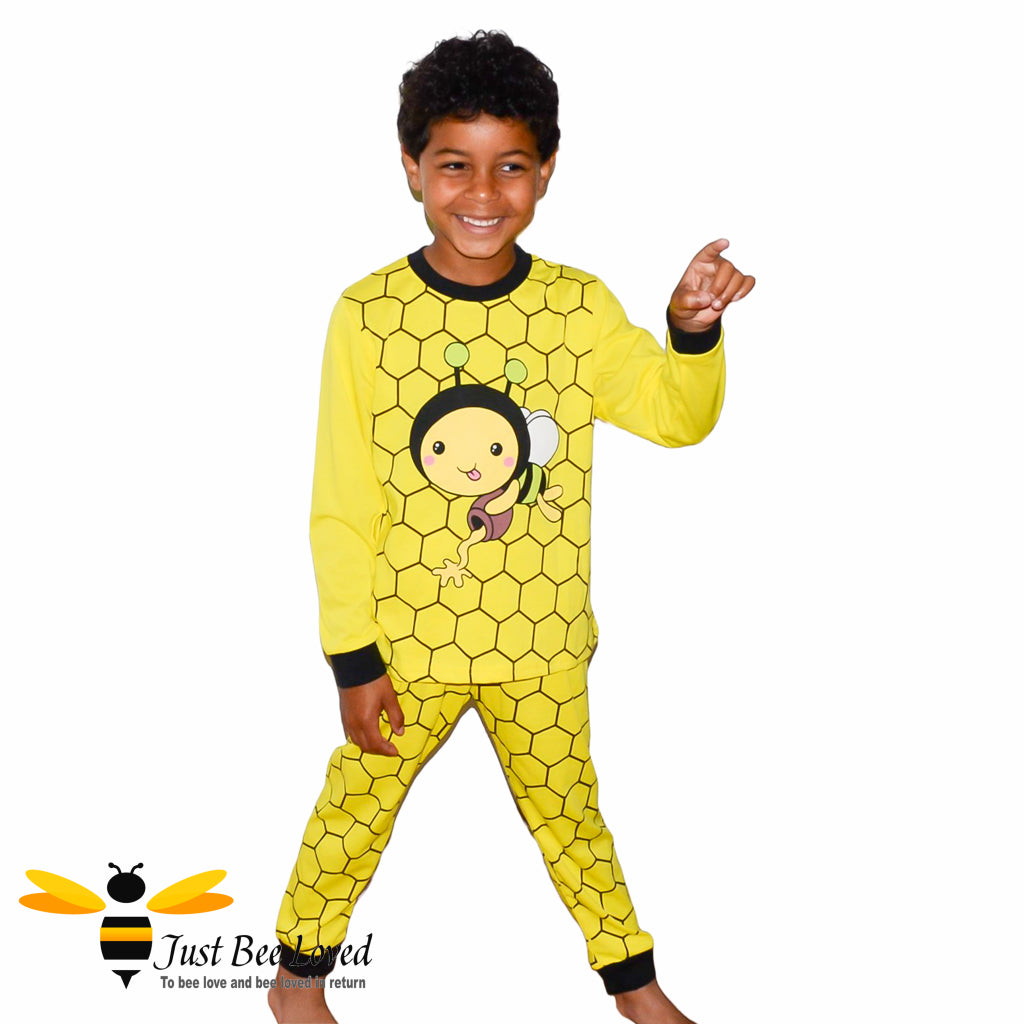 Boy's yellow honeycomb patterned pyjamas with a cartoon honeybee.