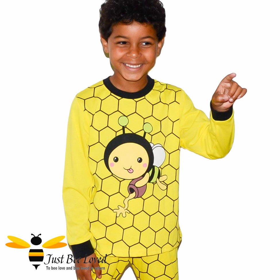 Boy's yellow honeycomb patterned pyjamas with a cartoon honeybee.