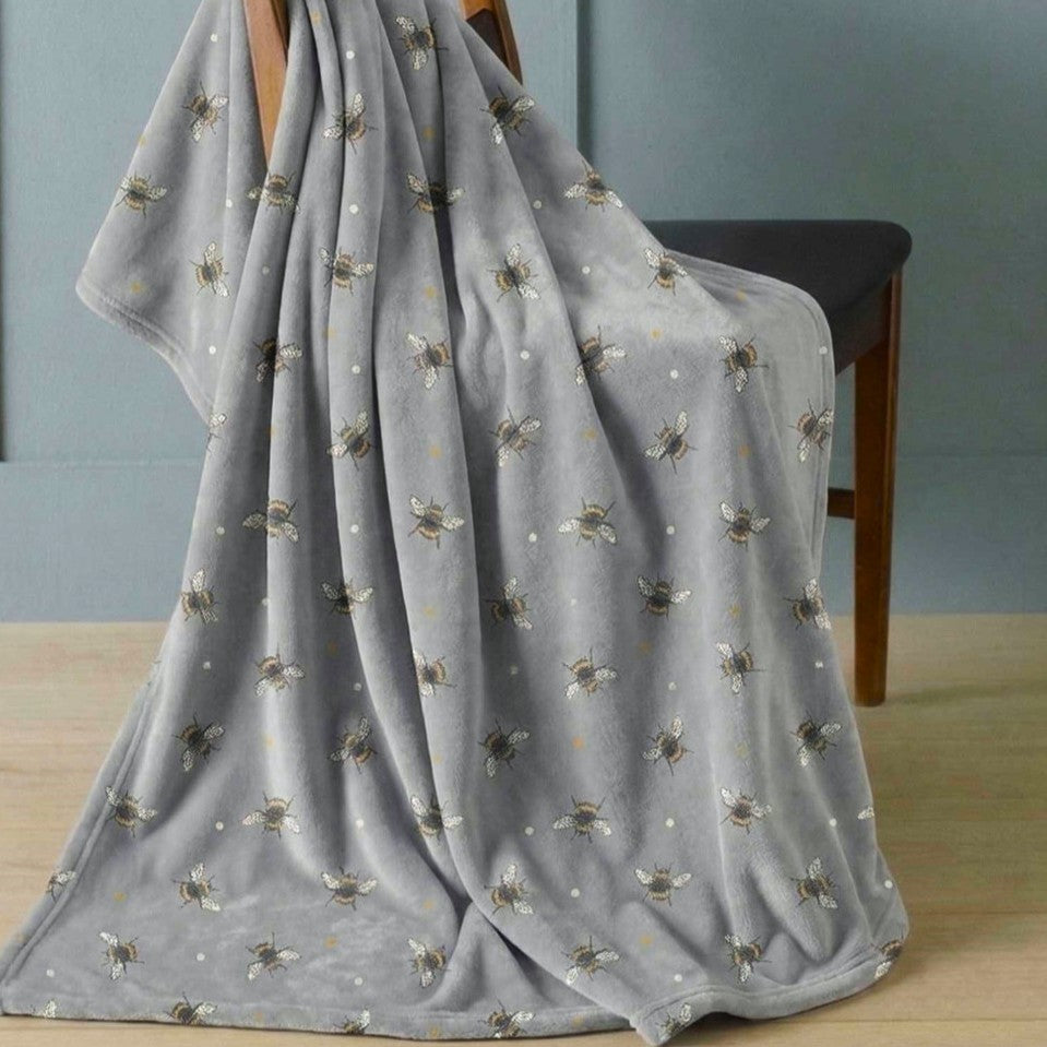 Grey flannel throw blanket featuring an all over bumble bees design.