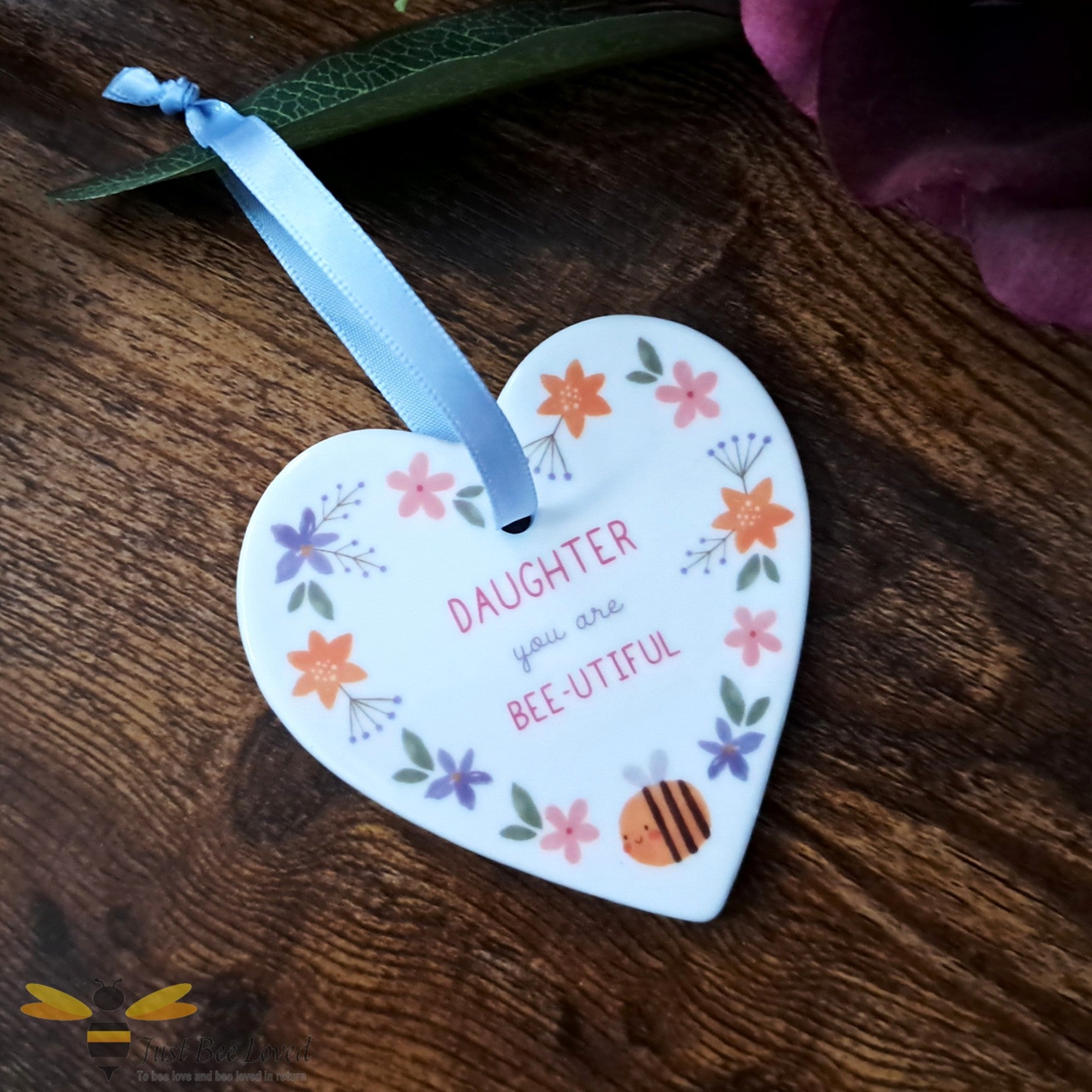 Ceramic heart shaped hanging plaque for a daughter with 'you are bee-utiful' message.  Decorated with bees and flowers.