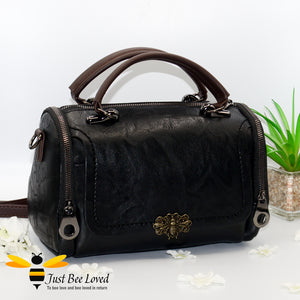 Boston styled faux leather barrel shaped black handbag featuring a vintage bronze bee embellishment.