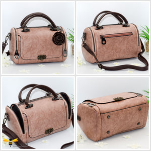Boston styled faux leather barrel shaped dusky pink handbag featuring a vintage bronze bee embellishment