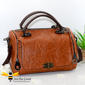 Boston styled faux leather barrel shaped brown handbag featuring a vintage bronze bee embellishment.
