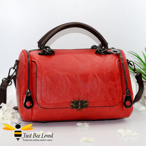Boston styled faux leather barrel shaped red handbag featuring a vintage bronze bee embellishment.