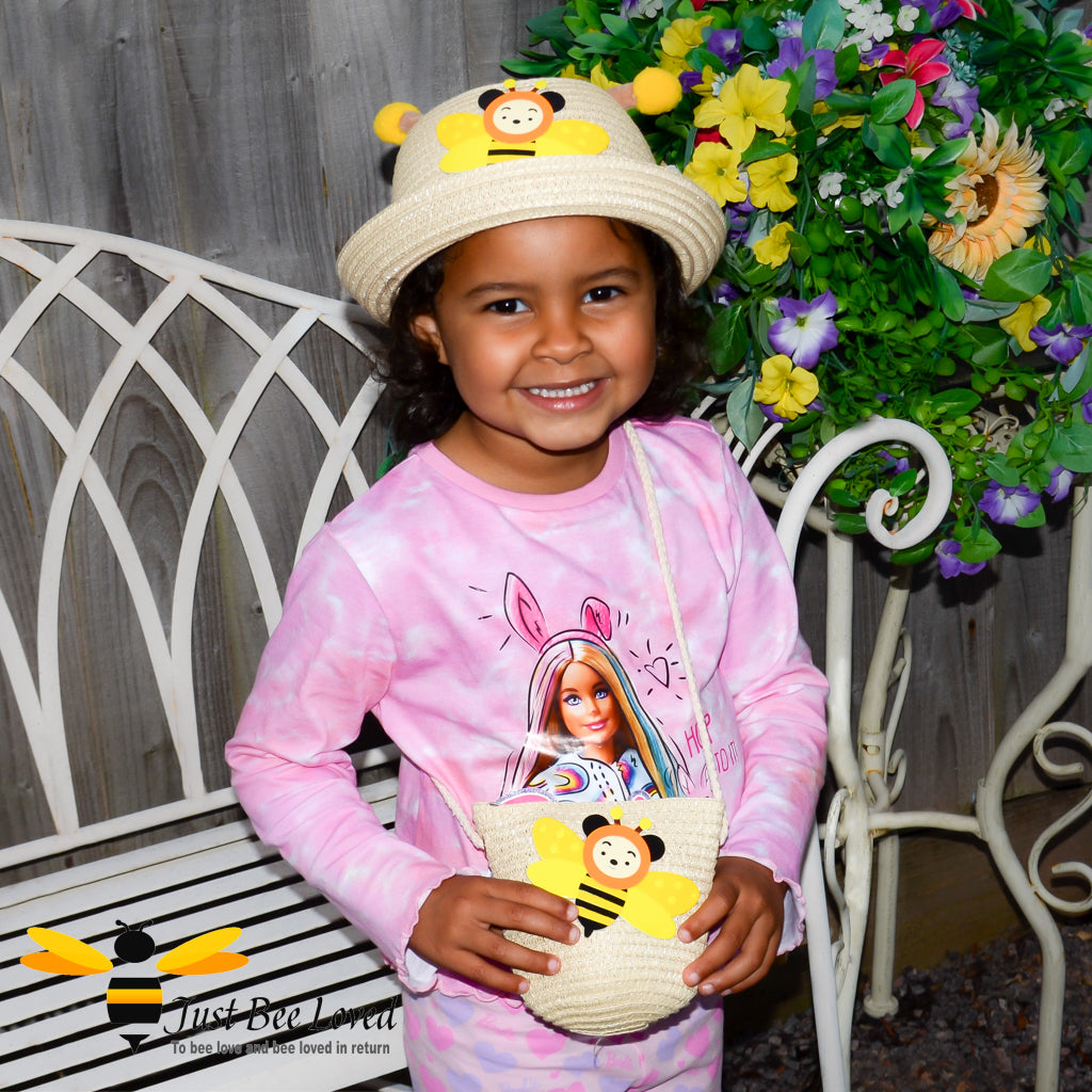 girl wearing  a bumble bee bowler straw hat with a matching bee bag