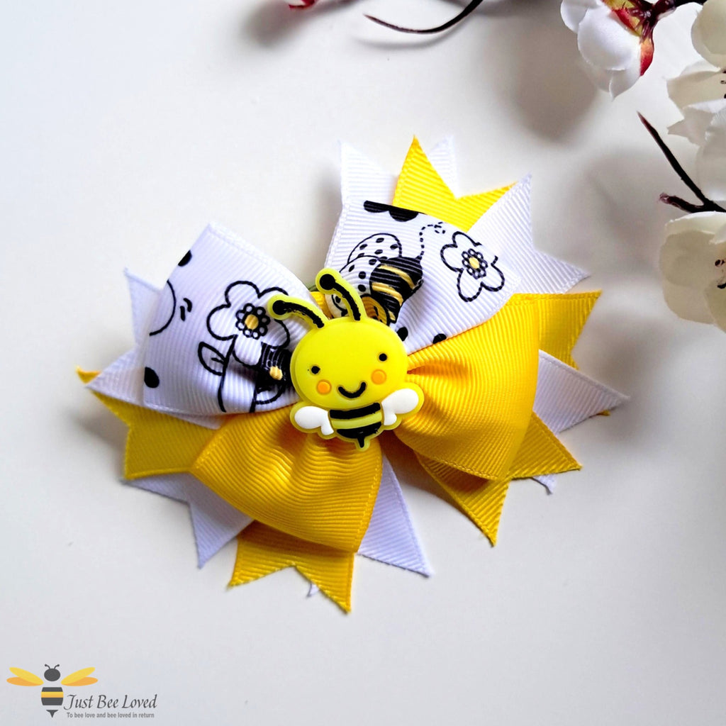 Yellow and white ribbon hair bow clip with bee design.