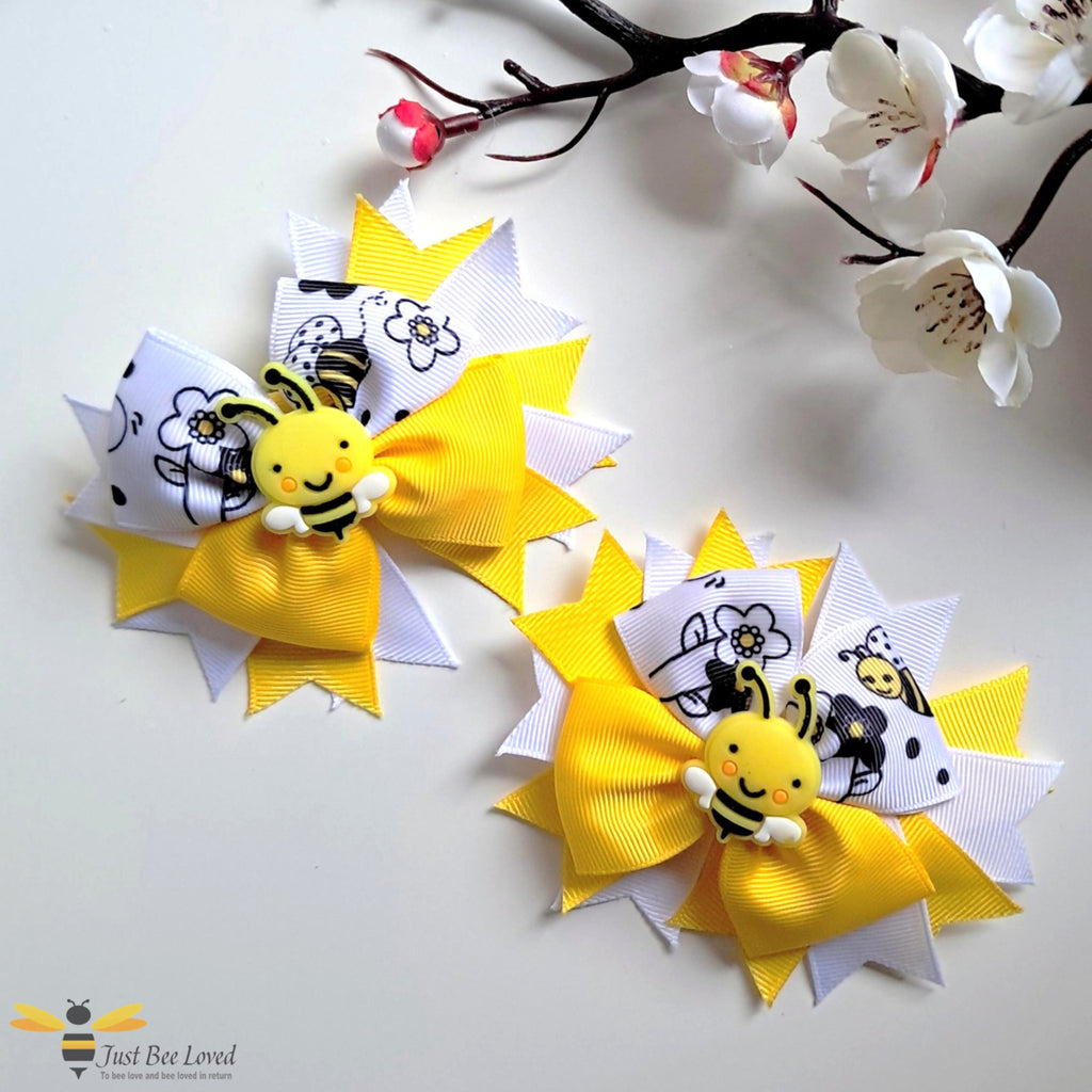 Pair of yellow and white ribbon hair clip bows with cute bumble bee pattern design.