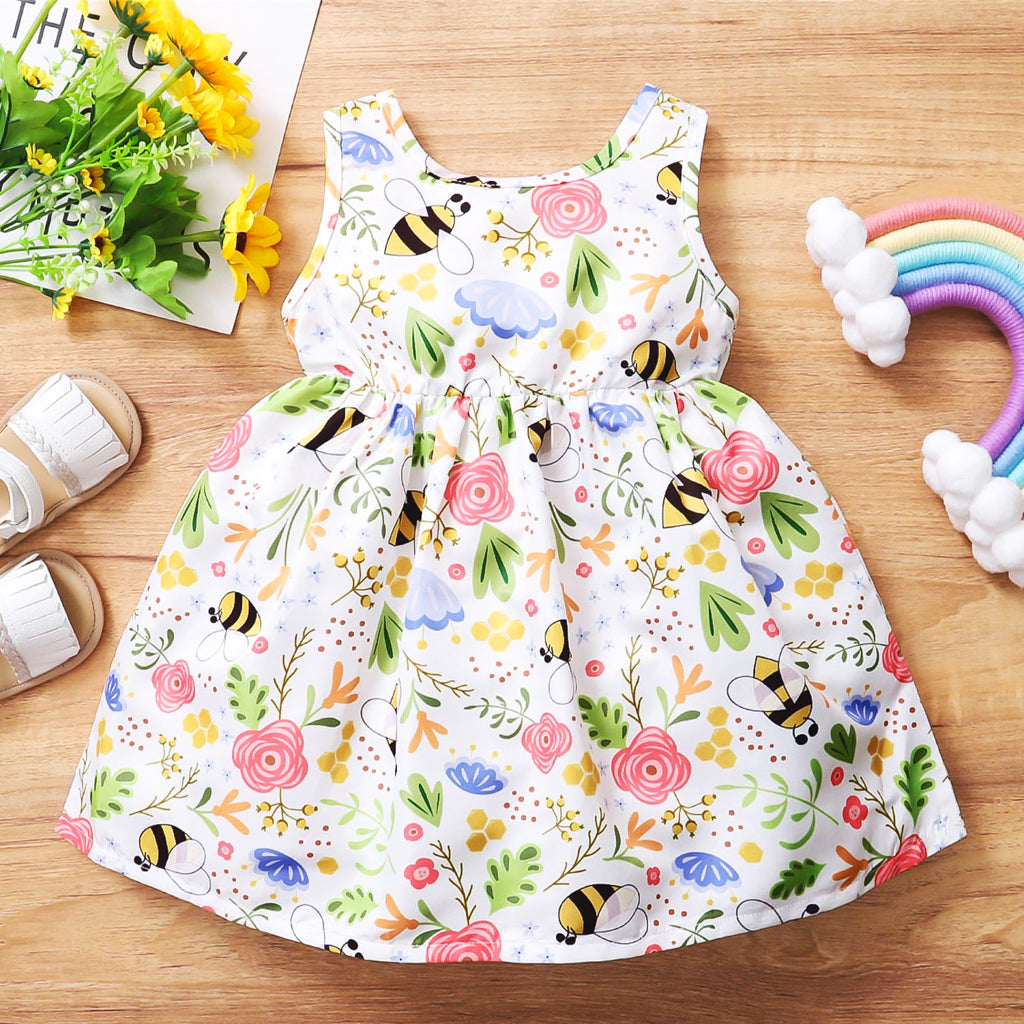 Girl's white summer smock dress with all over print of bees and flowers.