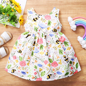 Girl's white summer smock dress with all over print of bees and flowers.