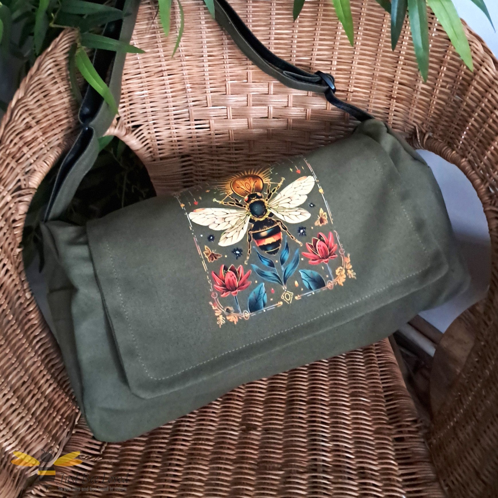 Khaki olive green canvas shoulder bag with a frontal bee, sun and floral design print.