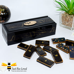 Set of handmade black and gold marble effect resin dominoes inlaid with gold bees in matching presentation box