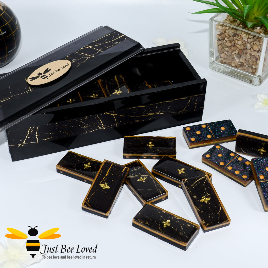 Set of handmade black and gold marble effect resin dominoes inlaid with gold bees in matching presentation box