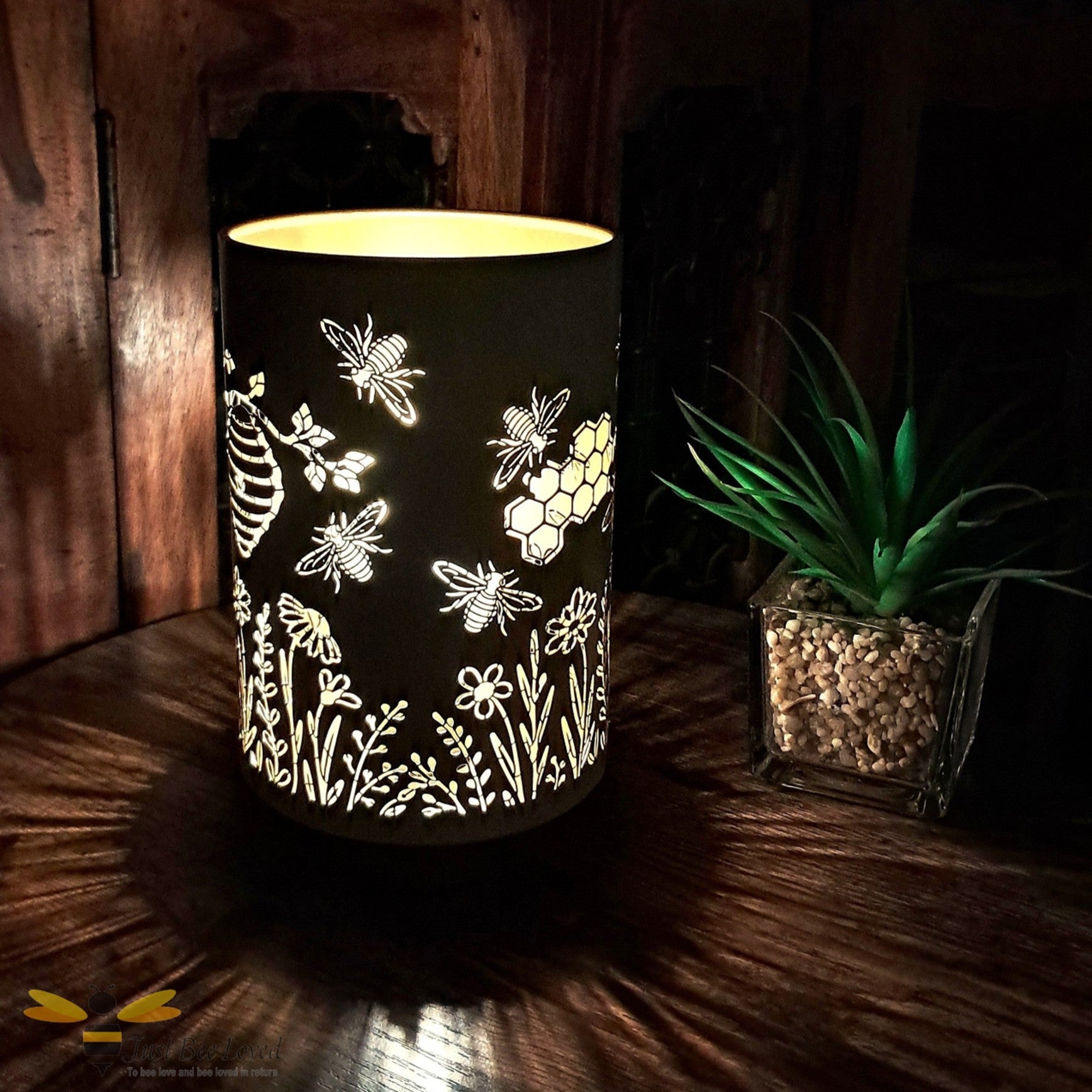 Metallic gold table lamp with bee and honeycomb silhouette design.