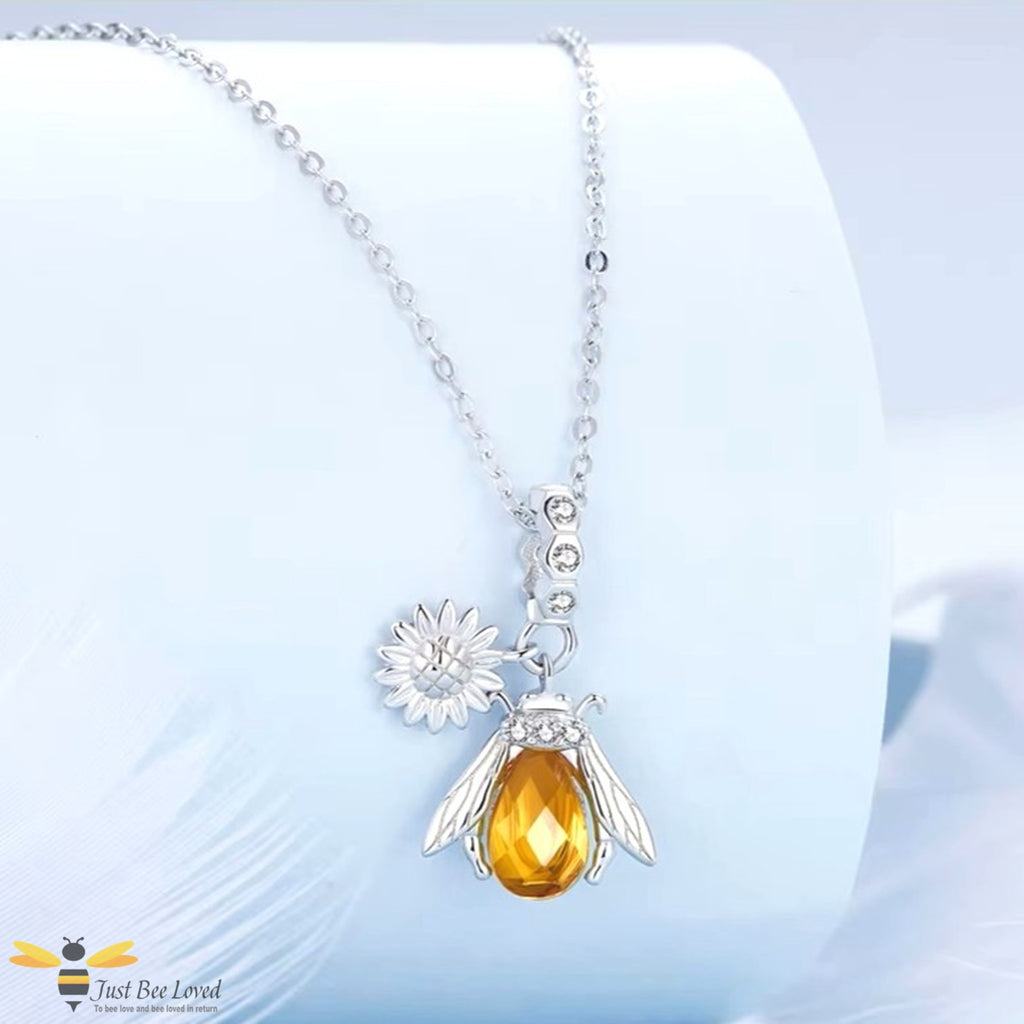Sterling silver honey bee pendant necklace with a silver sunflower charm.
