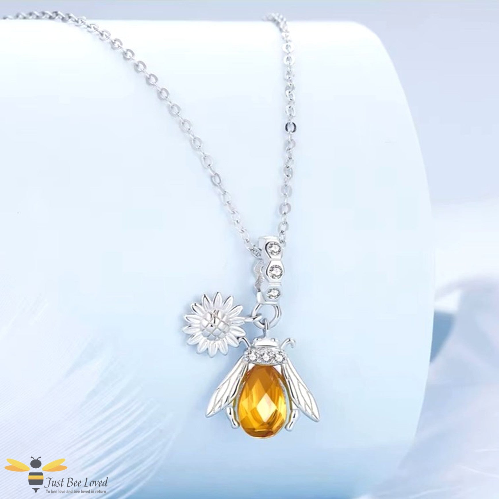 Sterling silver honey bee pendant necklace with a silver sunflower charm.