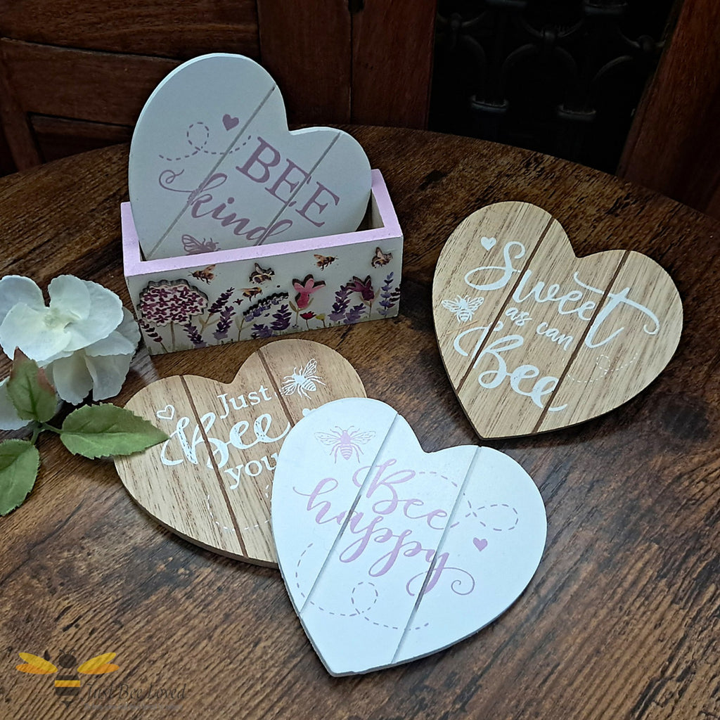 Set of 4 wooden heart shaped coasters with matching holder, featuring bees and flowers design, each with an inspirational bee themed message.