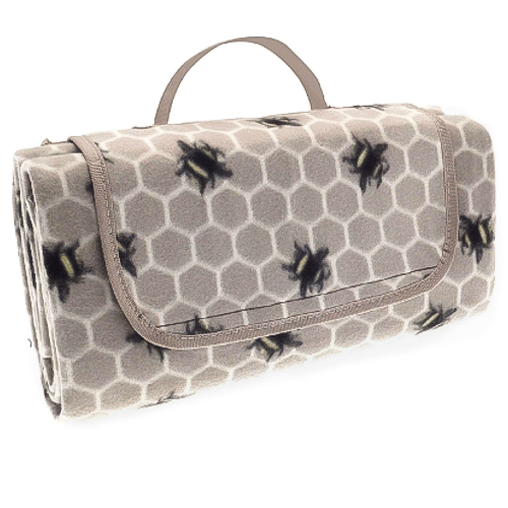 Foldable picnic fleece waterproof blanket with carry handle in taupe colour, with an all over honeycomb and bees print.