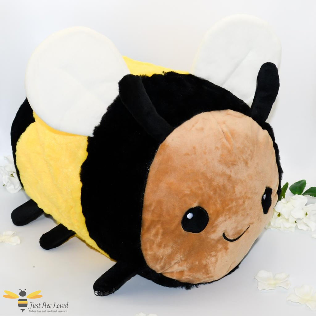 A large sized plush soft toy bee with a smiling face.