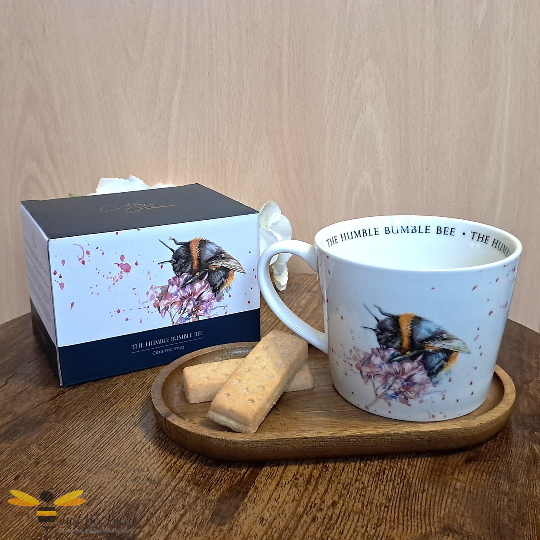 Meg Hawkins cream ceramic mug featuring an illustration of a foraging bumble bee.