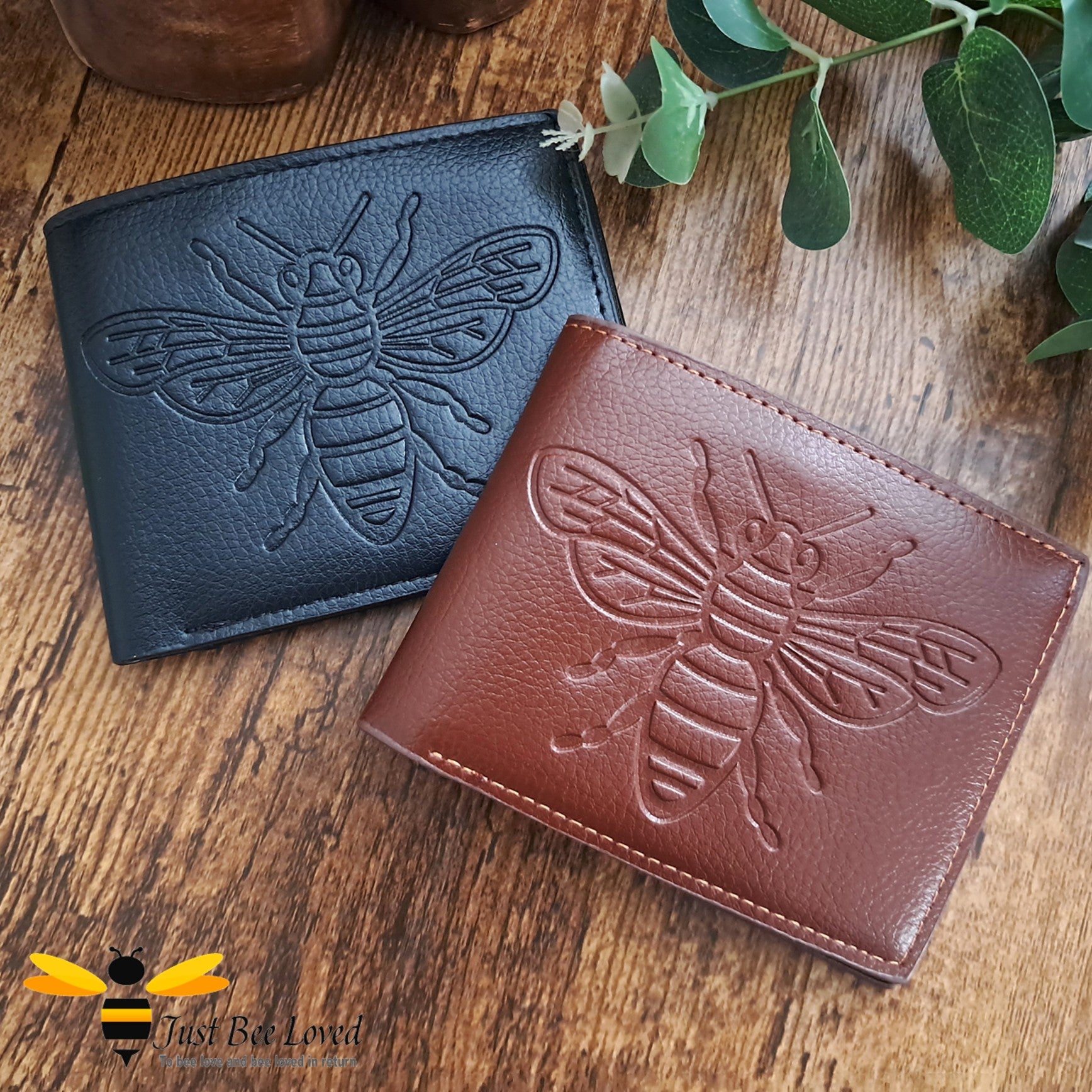 Black and brown leather wallets with large embossed bee design.