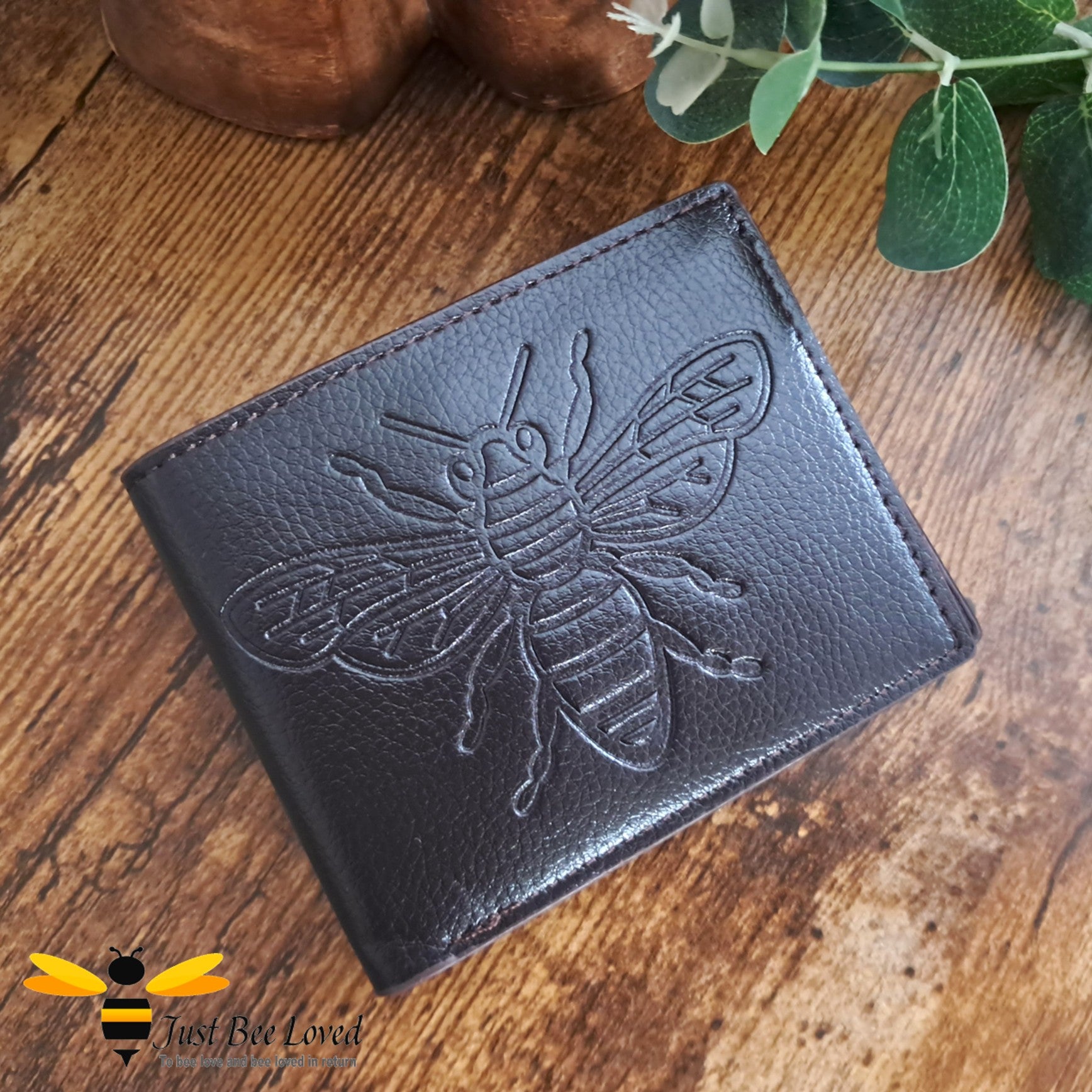 Dark brown leather wallet with large embossed bee design.