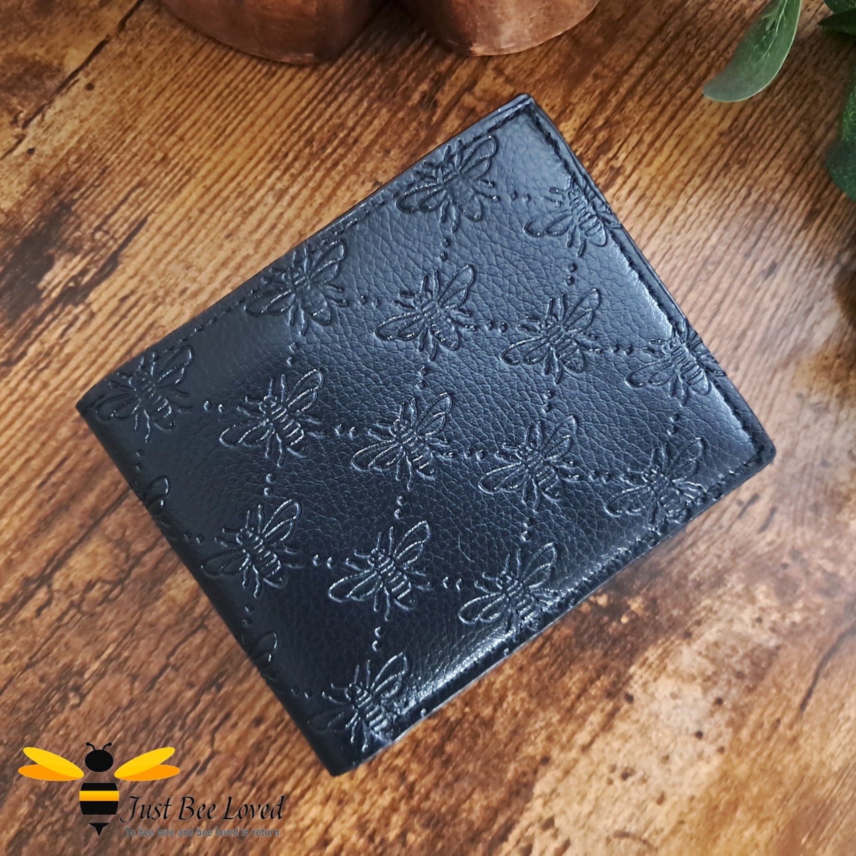 Black leather wallet with embossed all over bees criss-cross pattern design.