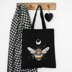 Black canvas tote bag with bumble bee, moon, stars